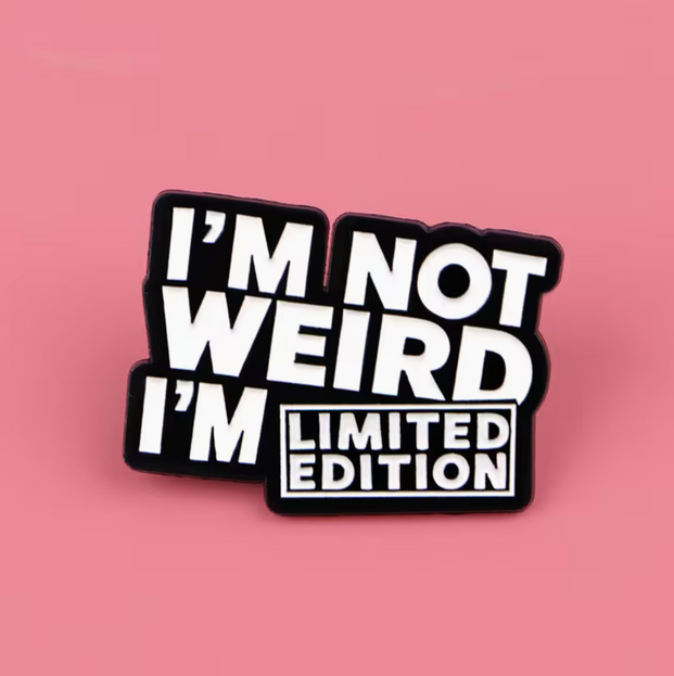 'I'm not weird I'm limited edition' black and white enamel Pin